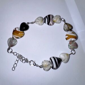 Elegant Heart Charm Bracelet with Black, White, and Gold Accents